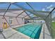 A beautiful screened-in pool with brick surround and lounge chairs, perfect for outdoor enjoyment at 2021 Elk Spring Dr, Brandon, FL 33511