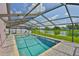 Backyard boasts a screened pool area with scenic lake views at 2021 Elk Spring Dr, Brandon, FL 33511