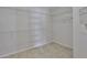 Walk-in closet with white wire shelving and neutral tile floors at 2021 Elk Spring Dr, Brandon, FL 33511