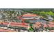 A captivating aerial view showcasing a beautiful red-roofed townhome community and the lovely waterfront area it neighbors at 2363 Hanover Dr, Dunedin, FL 34698