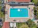 Overhead view of a community pool with ample lounge seating and a nearby hot tub at 2363 Hanover Dr, Dunedin, FL 34698