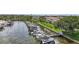 Scenic aerial of boat docks alongside lush lawns and mature trees in a residential neighborhood at 2363 Hanover Dr, Dunedin, FL 34698