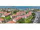Aerial view of waterfront community with multiple docks, mature landscaping, and red tile roofs at 2363 Hanover Dr, Dunedin, FL 34698