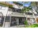 Lawn view of backyard, screen enclosed patio, palm trees and sunny skies at 2363 Hanover Dr, Dunedin, FL 34698