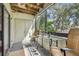 Cozy balcony with a ceiling fan, seating, and a view of lush greenery at 2363 Hanover Dr, Dunedin, FL 34698