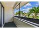 A peaceful balcony view, framed by palm trees and blue skies at 2363 Hanover Dr, Dunedin, FL 34698