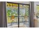 Inviting balcony featuring a seating area with a ceiling fan and a scenic view through sliding glass doors at 2363 Hanover Dr, Dunedin, FL 34698