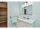 Well-lit bathroom featuring a modern vanity, updated fixtures, and light blue walls at 2363 Hanover Dr, Dunedin, FL 34698