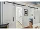 Bathroom entrance with white sliding doors and stylish decor, creating a modern and inviting space at 2363 Hanover Dr, Dunedin, FL 34698