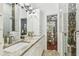 Bathroom featuring a glass enclosed shower with mosaic tile accents and double sink vanity at 2363 Hanover Dr, Dunedin, FL 34698