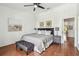 Well-lit main bedroom with hardwood floors, ceiling fan and natural light at 2363 Hanover Dr, Dunedin, FL 34698