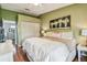 Cozy bedroom boasts a closet, an art piece, and wood floors at 2363 Hanover Dr, Dunedin, FL 34698