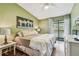 Spacious bedroom with hardwood floors, a vaulted ceiling, and a sliding glass door to a balcony at 2363 Hanover Dr, Dunedin, FL 34698