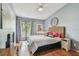 Cozy bedroom with hardwood floors, gray walls, and a sliding glass door to a balcony at 2363 Hanover Dr, Dunedin, FL 34698