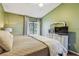 Relaxing bedroom featuring calm green walls, and a large window offering natural light at 2363 Hanover Dr, Dunedin, FL 34698