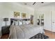Spacious primary bedroom featuring hardwood floors, a bench, and ample natural light at 2363 Hanover Dr, Dunedin, FL 34698