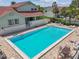 Inviting community pool area with lounge chairs and tables for relaxing by the water at 2363 Hanover Dr, Dunedin, FL 34698