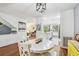 Well-lit dining room with hardwood floors adjacent to the living room and kitchen at 2363 Hanover Dr, Dunedin, FL 34698