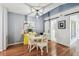 A modern dining room boasts wood floors, stylish decor, and a chic yellow cabinet at 2363 Hanover Dr, Dunedin, FL 34698