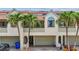 Charming exterior showcasing lush palm trees, garage, and inviting curb appeal, with a coastal vibe at 2363 Hanover Dr, Dunedin, FL 34698