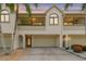 Inviting townhome with a two-car garage, lush landscaping, and a charming architectural design at 2363 Hanover Dr, Dunedin, FL 34698