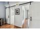 Bright hallway with sliding barn doors leading to a stylish bathroom, complemented by hardwood floors at 2363 Hanover Dr, Dunedin, FL 34698
