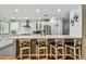 Open-concept kitchen featuring a breakfast bar with seating, modern appliances, and stylish white cabinetry at 2363 Hanover Dr, Dunedin, FL 34698