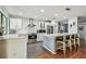 Bright, modern kitchen with stainless steel appliances, white cabinetry, quartz countertops, and barstool seating at 2363 Hanover Dr, Dunedin, FL 34698