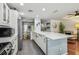 Spacious kitchen with stainless steel appliances, sleek countertops, and an open layout flowing to dining area at 2363 Hanover Dr, Dunedin, FL 34698