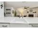 Close up of the kitchen, featuring a deep farm sink and sleek stone counters, blending seamlessly with the living space at 2363 Hanover Dr, Dunedin, FL 34698