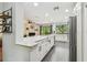 Bright open kitchen with large island and stainless appliances seamlessly connected to the cozy living room at 2363 Hanover Dr, Dunedin, FL 34698