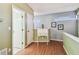 Upstairs landing featuring hardwood floors, a stylish desk, and doors leading to other rooms at 2363 Hanover Dr, Dunedin, FL 34698