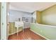 Charming landing area with hardwood floors, a vintage desk, and ample natural light from clerestory windows at 2363 Hanover Dr, Dunedin, FL 34698