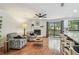 Inviting living room featuring a cozy fireplace, hardwood floors, and plenty of natural light at 2363 Hanover Dr, Dunedin, FL 34698