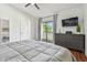 Bright main bedroom with balcony access, stylish dresser, and a ceiling fan for added comfort at 2363 Hanover Dr, Dunedin, FL 34698