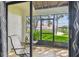 Screened patio offering a serene view of the marina and lush greenery at 2363 Hanover Dr, Dunedin, FL 34698