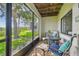 Comfortable screened porch with seating, perfect for enjoying the outdoors at 2363 Hanover Dr, Dunedin, FL 34698