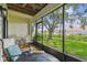 Relaxing screened-in porch overlooking green space and the marina at 2363 Hanover Dr, Dunedin, FL 34698