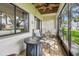 Covered porch with comfortable seating, ideal for relaxing with a view at 2363 Hanover Dr, Dunedin, FL 34698