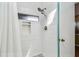 Modern shower with white subway tile, a small window, and a shower head at 2363 Hanover Dr, Dunedin, FL 34698