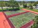 Community tennis courts surrounded by lush greenery and mature shade trees at 2363 Hanover Dr, Dunedin, FL 34698