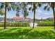 A lush green lawn view of the channel with boats in a boat storage unit at 2363 Hanover Dr, Dunedin, FL 34698