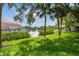 Backyard lawn view of a waterfront channel with boats and sunny skies at 2363 Hanover Dr, Dunedin, FL 34698
