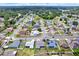 An aerial view of a community with trees, lawns, and different roof and home colors at 23917 Pow Wow Dr, Lutz, FL 33559