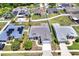 An aerial view of a home with a beautiful backyard, neighborhood, and white fence at 23917 Pow Wow Dr, Lutz, FL 33559