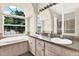 Bathroom suite features dual sinks, a soaking tub, large window, and separate shower at 23917 Pow Wow Dr, Lutz, FL 33559