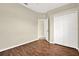 Bedroom featuring hardwood floors, neutral paint, a closet, and a view to the entry hall at 23917 Pow Wow Dr, Lutz, FL 33559