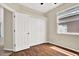 This bedroom is well-lit with wood floors and a closet with white doors and gold knobs at 23917 Pow Wow Dr, Lutz, FL 33559