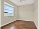 Bedroom with hardwood flooring, neutral paint, and a large window at 23917 Pow Wow Dr, Lutz, FL 33559