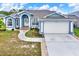 Charming single-story home with a well-manicured lawn and a two-car garage at 23917 Pow Wow Dr, Lutz, FL 33559